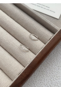 Close-up of S925 silver hoop earrings with zircon V-shape design in a display box