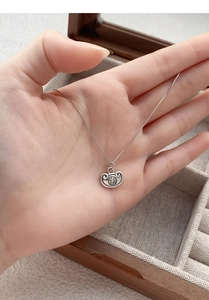 Macro shot of S925 sterling silver necklace featuring a Sycee pendant with Fu character