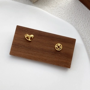Asymmetric S925 silver horse and coin stud earrings with a matte gold finish
