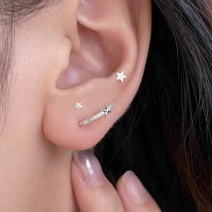 S925 silver star stud earrings set with zircon stones on female ear model close-up