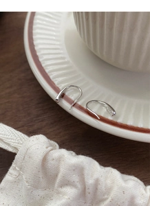 Detailed close-up of S925 sterling silver drop earrings with cotton gift pouch