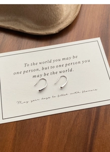 Minimalist S999 sterling silver teardrop hook earrings displayed on a white gift card
