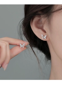 Macro shot of S999 sterling silver butterfly stud earrings featuring delicate zircon stones