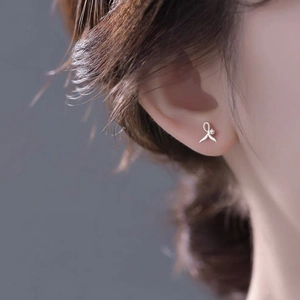 Elegant S999 sterling silver fishtail stud earrings with white zircon on earlobe