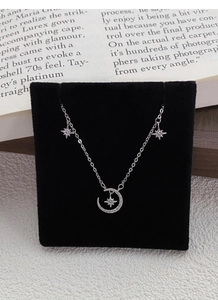 Detailed view of S999 sterling silver moon and star necklace with sparkling zircons