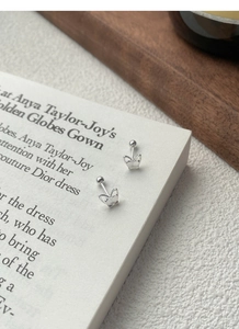 Macro side view of polished sterling silver double butterfly stud earrings with screw backs