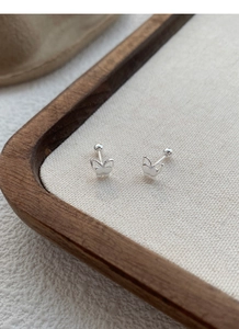 Detailed macro view of 999 sterling silver butterfly stud earrings with screw-back closures