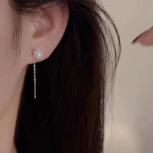 Elegant S925 sterling silver dandelion tassel chain earrings worn on model's ear