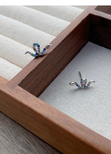 Detail of S925 sterling silver snake earrings featuring vibrant multi-colored zircon stones