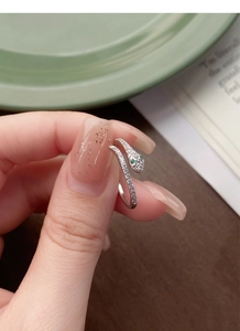 Detailed close-up of S925 sterling silver snake ring with green gem eyes and crystals