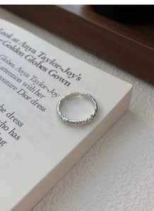 Macro shot of 999 sterling silver open ring with unique candy paper hammered texture