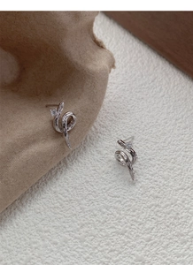 Macro shot of S925 sterling silver snake earrings with sparkling cubic zirconia stones