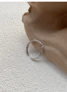 Detail view of adjustable 999 silver ring featuring unique crushed paper texture finish
