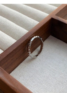 Macro detail of sterling silver ring with irregular hammered texture on jewelry box