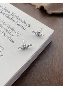 Close-up of S925 silver stud earrings with colorful zircon stones in a bird-like shape