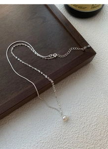 Dettaglio del marchio S925 sulla collana a doppio strato con perla d'acqua dolce