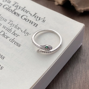 S925 sterling silver snake ring with white diamonds and green stone eyes on book