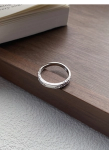 Macro detail of S999 sterling silver ring showing intricate relief texture and hallmark