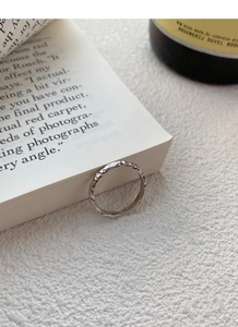 Detail showing the irregular sugar-paper texture on a 999 sterling silver open ring