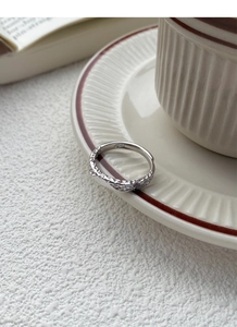 Close-up of S999 sterling silver ring featuring a unique molten lava texture and open band