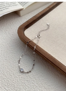 Macro shot of S925 sterling silver chain with a sparkling cubic zirconia and lobster clasp