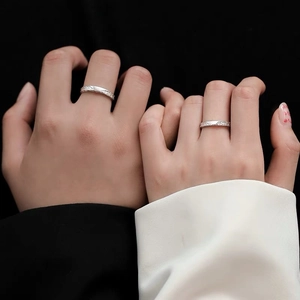 Minimalist S999 silver glacier couple rings featuring fine textured wave engravings