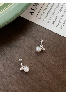 Detailed macro view of 999 sterling silver butterfly pearl earrings with screw back design