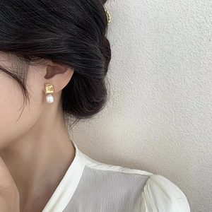 Baroque freshwater pearl drop earrings in S925 sterling silver worn by a model