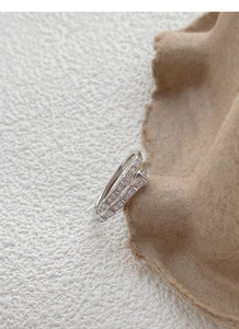 Macro shot of silver snake-shaped open ring with cubic zirconia micro-pave detailing