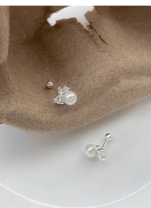 Macro detail of 999 sterling silver butterfly pearl earrings with secure screw back