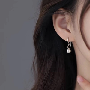 Elegant S925 sterling silver spiral earrings with round freshwater pearls on model