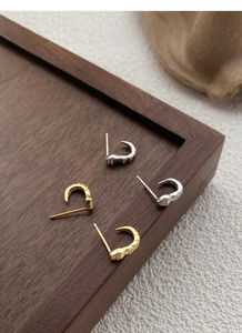 Close-up of S925 sterling silver snake earrings with pavé crystals in gold and silver