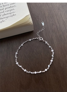 Detail of S925 sterling silver rose flower bracelet with adjustable chain on wood
