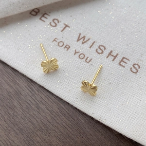 Elegant gold S925 silver four-leaf clover stud earrings with radiant textured engraving