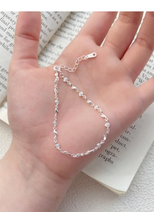 Detail of S925 sterling silver rose bracelet with small white diamonds and metal stamp