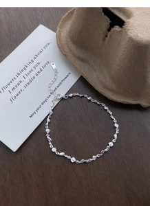 Detail of S925 sterling silver rose bracelet with zircon accents and lobster clasp