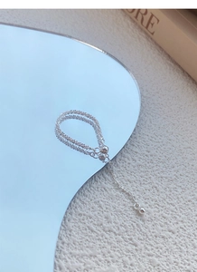 Detail of silver double-layered chain with grid texture and small round bead accents