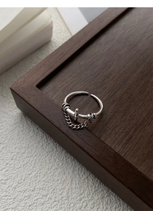 Close-up of S925 sterling silver vintage cross ring with dangling chain decoration
