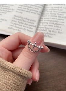 Detailed close-up of S925 sterling silver cross ring with chain on model finger