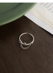 Macro shot of S925 sterling silver vintage chain cross ring with industrial punk design