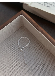 Macro detail of a beaded S925 sterling silver ring with an adjustable slider chain