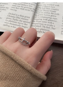 Detailed macro view of S925 sterling silver vintage chain cross ring on finger