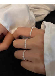 Three thin S925 sterling silver textured rings worn together on fingers for a layered look
