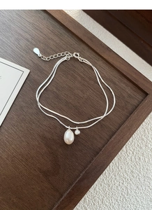 Detail of S925 sterling silver double-layer snake chain with a white baroque pearl pendant