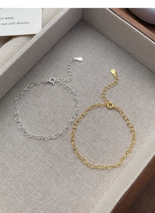 Detailed macro view of S925 sterling silver heart chain bracelets in gold and silver finish