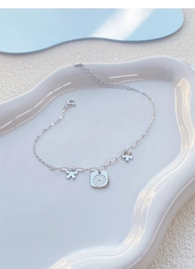 Macro detail of S925 sterling silver daisy bracelet with lobster clasp and extension chain