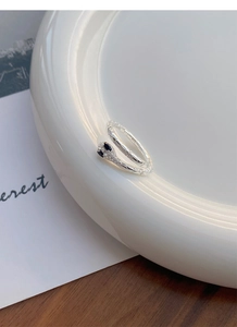 Macro detail of silver snake ring with textured scales and sparkling diamond head