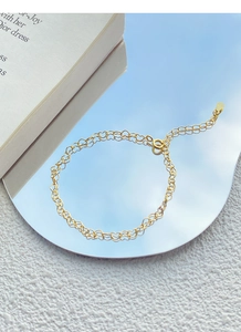 Detailed view of S925 sterling silver golden chain bracelet with double-row hollow hearts