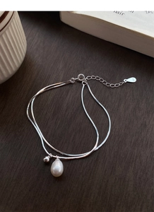 Detailed close-up of S925 silver double-layered snake chain bracelet with white pearl