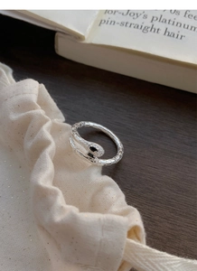 Close-up of S925 sterling silver snake ring with white zircons and black gemstone eyes